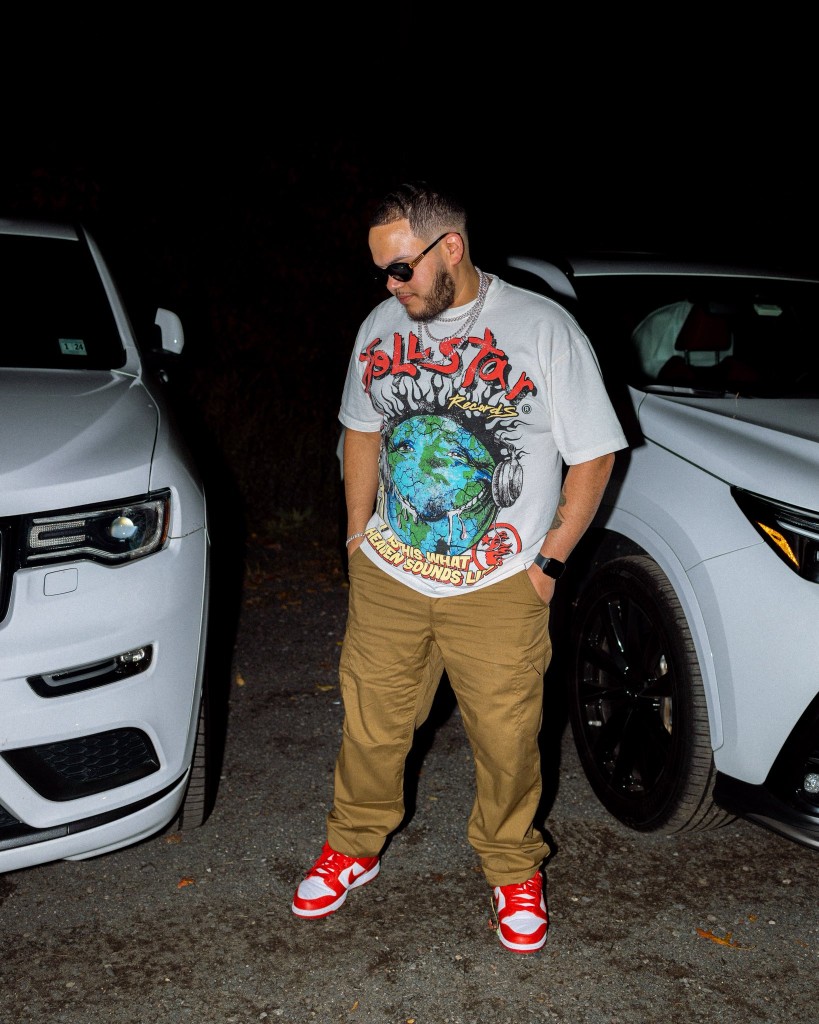 Raf outdoors at night between two vehicles